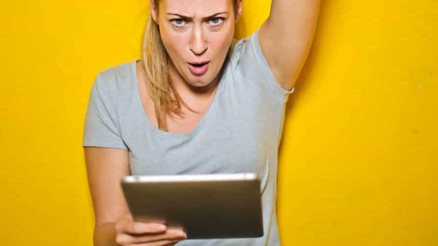 photo of a woman holding an ipad